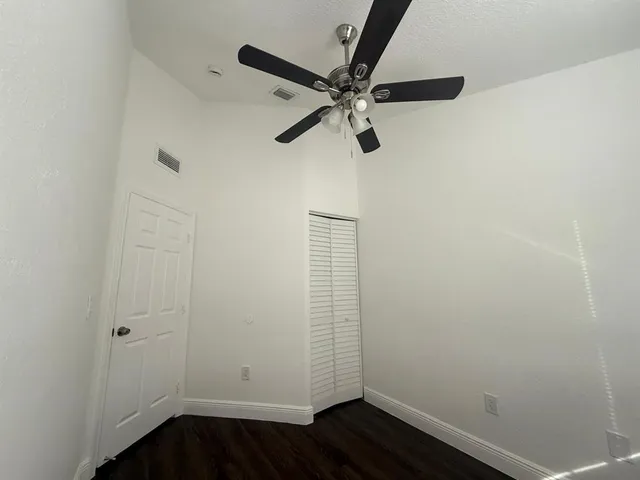 a view of a room with wooden floor