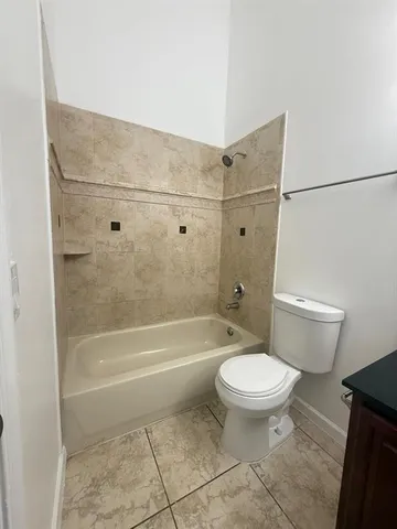 a bathroom with a toilet and a bath tub