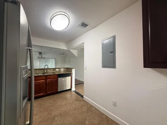 a kitchen with stainless steel appliances granite countertop a stove and a refrigerator
