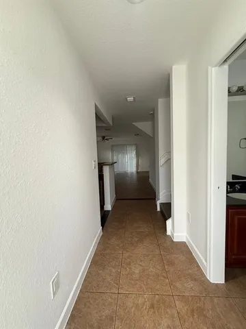 a view of a hallway with wooden shelves