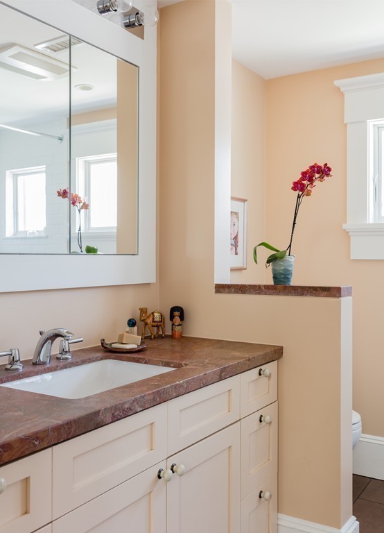 8 Vineyard Street Cambridge, MA 02138 - Photo 11 of 15 a bathroom with a granite countertop sink and a mirror