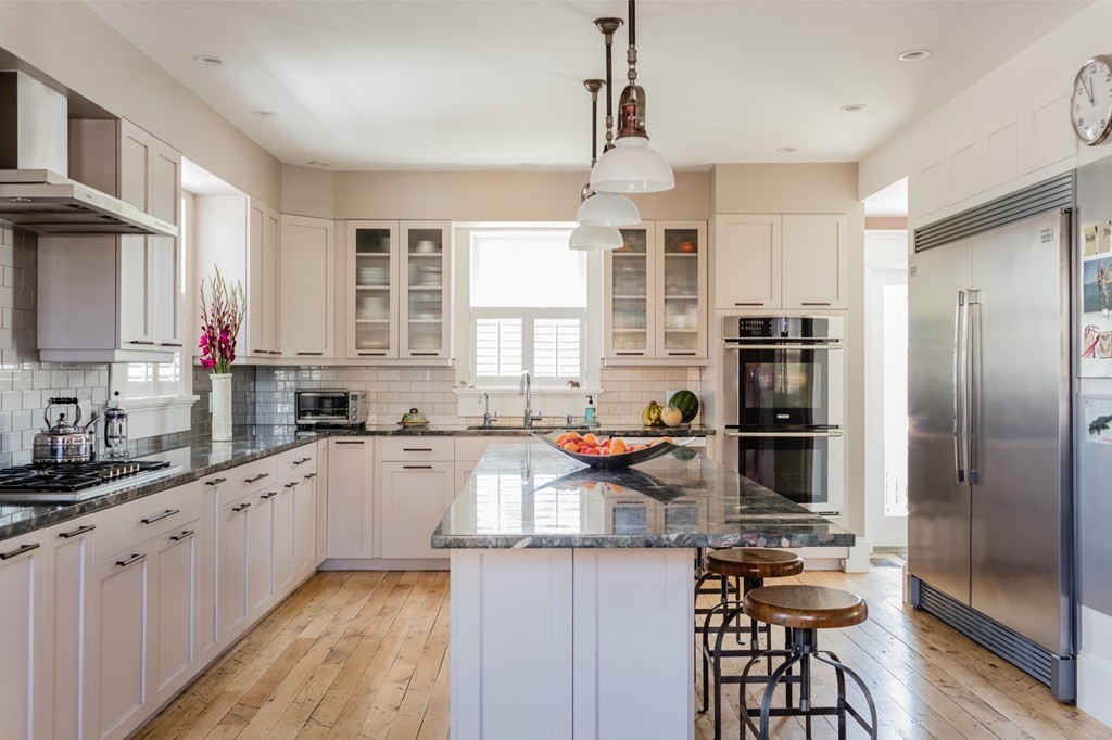 8 Vineyard Street Cambridge, MA 02138 - Photo 2 of 15 a kitchen with stainless steel appliances granite countertop a sink stove refrigerator and cabinets