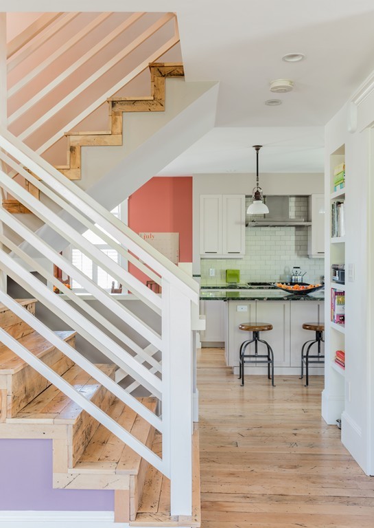8 Vineyard Street Cambridge, MA 02138 - Photo 4 of 15 a kitchen with kitchen island stainless steel appliances a table chairs in it and wooden floors