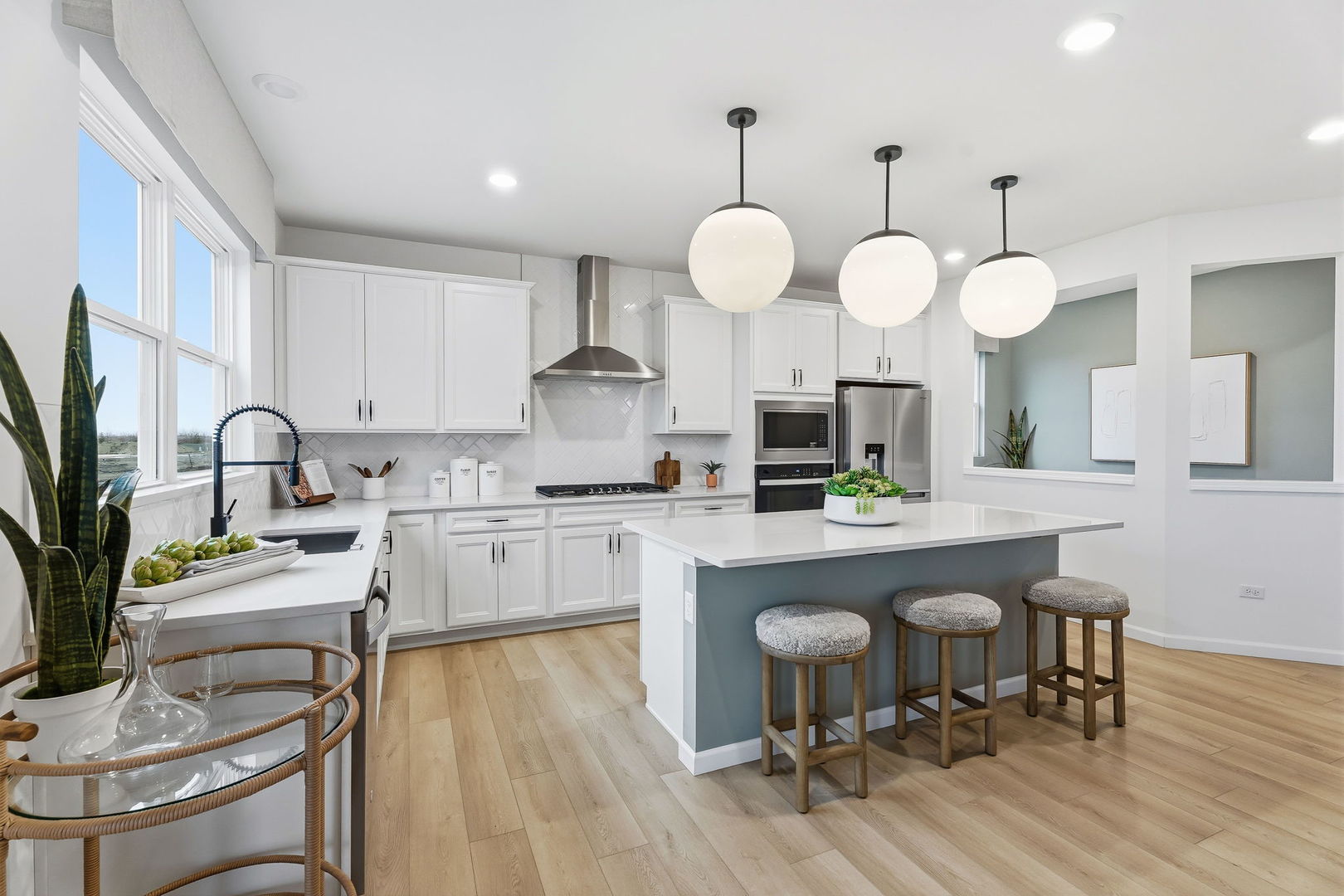 605 Redtop Way Bolingbrook, IL 60490 - Photo 3 of 22 a kitchen with a table chairs sink and cabinets