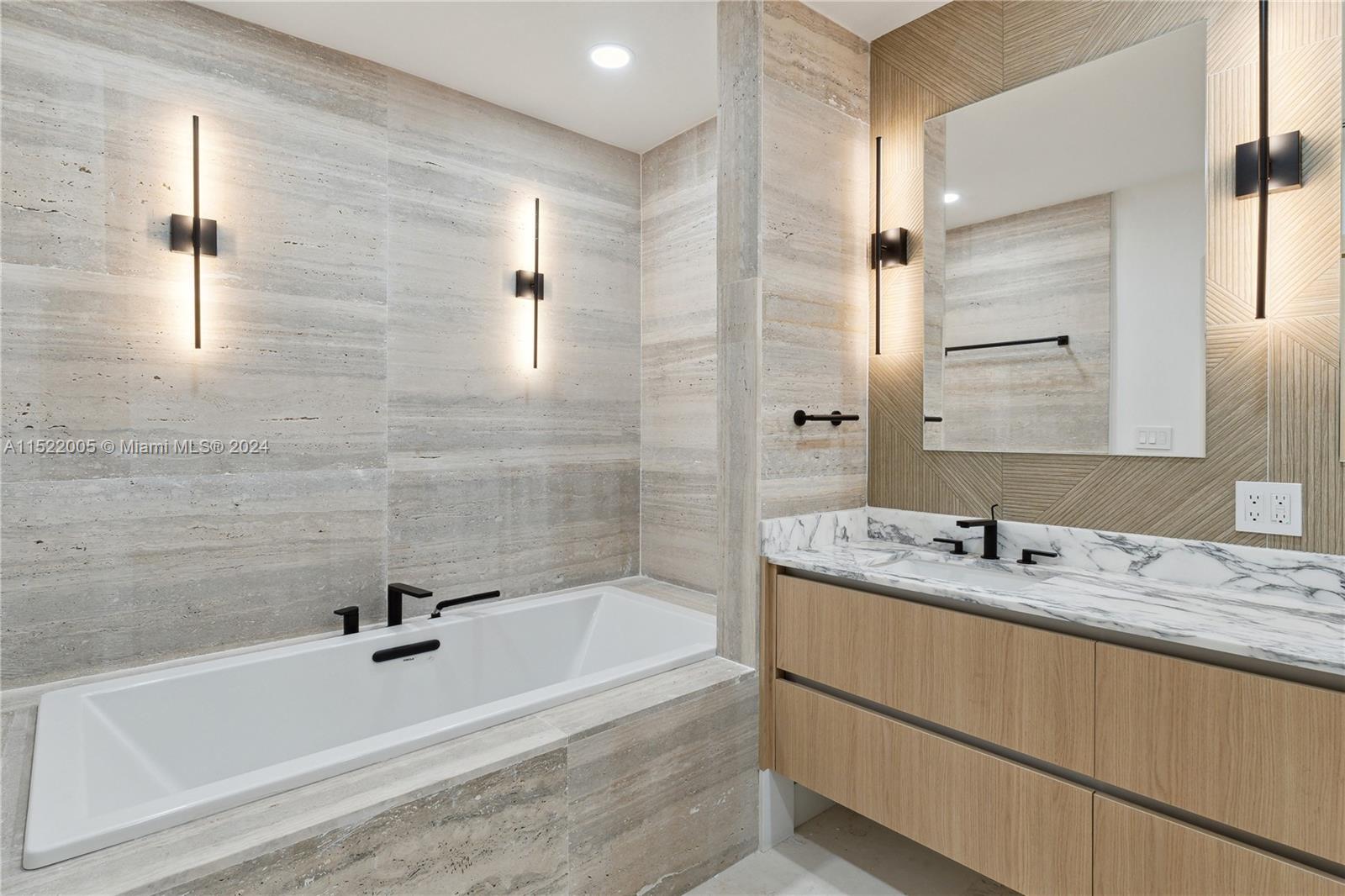 519 Southwest 25th Road Miami, FL 33129 - Photo 16 of 43 a bathroom with a granite countertop bathtub shower sink and mirror