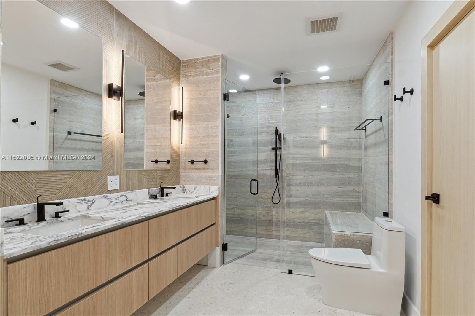519 Southwest 25th Road Miami, FL 33129 - Photo 19 of 43 a bathroom with a granite countertop sink a toilet a mirror and shower