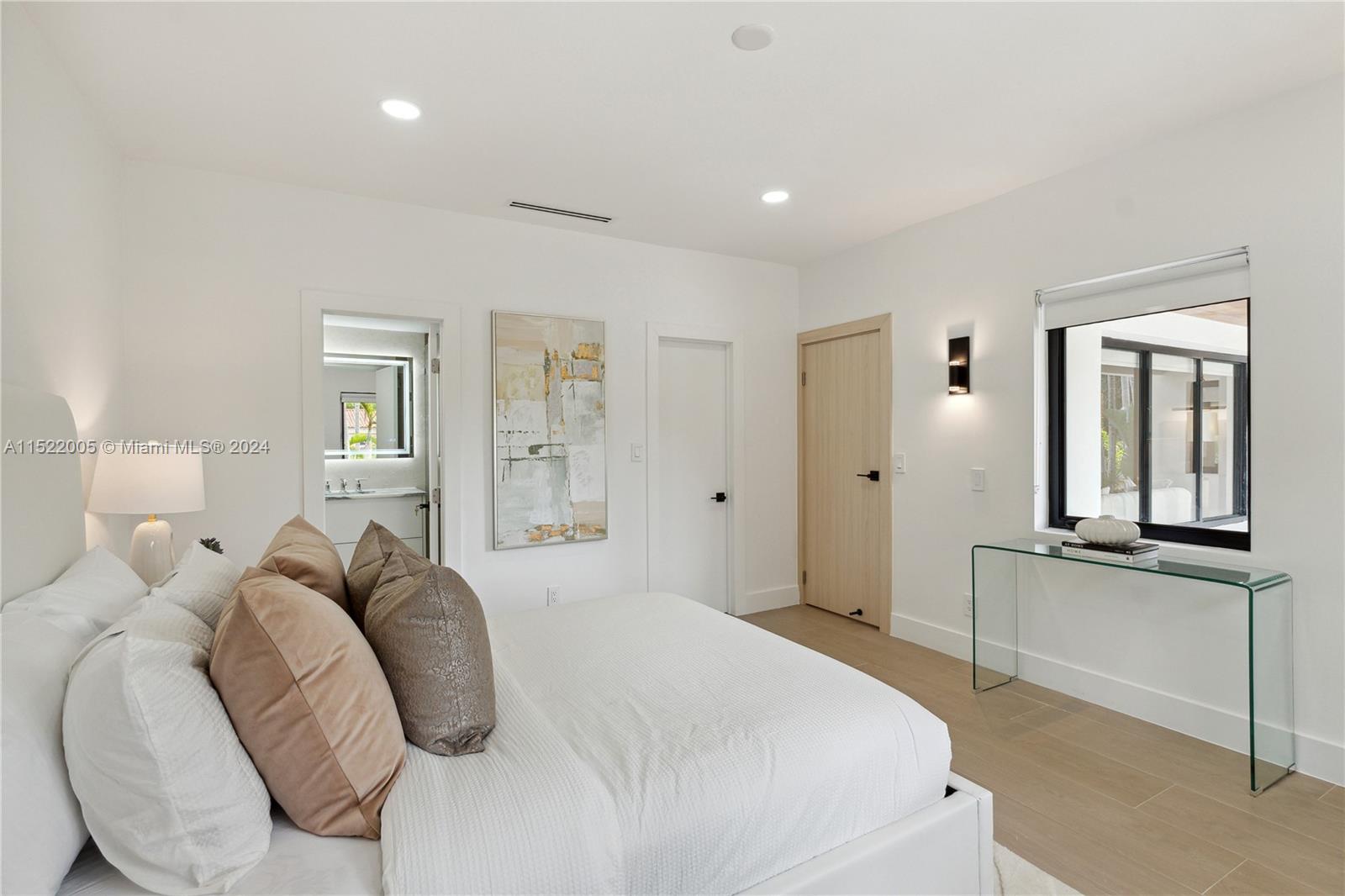 519 Southwest 25th Road Miami, FL 33129 - Photo 21 of 43 a spacious bedroom with a bed and glass windows