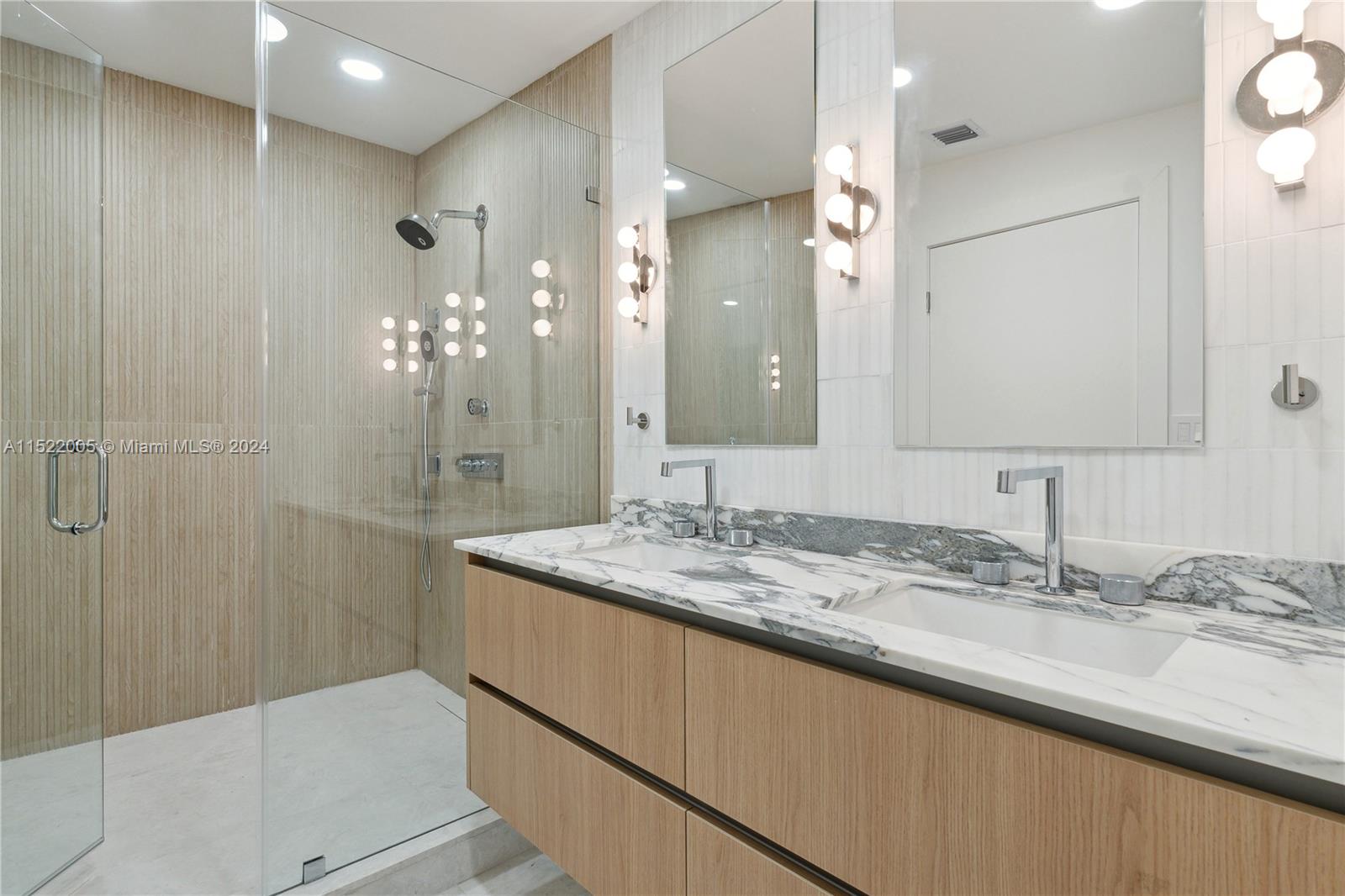 519 Southwest 25th Road Miami, FL 33129 - Photo 24 of 43 a bathroom with a granite countertop sink mirror and a shower