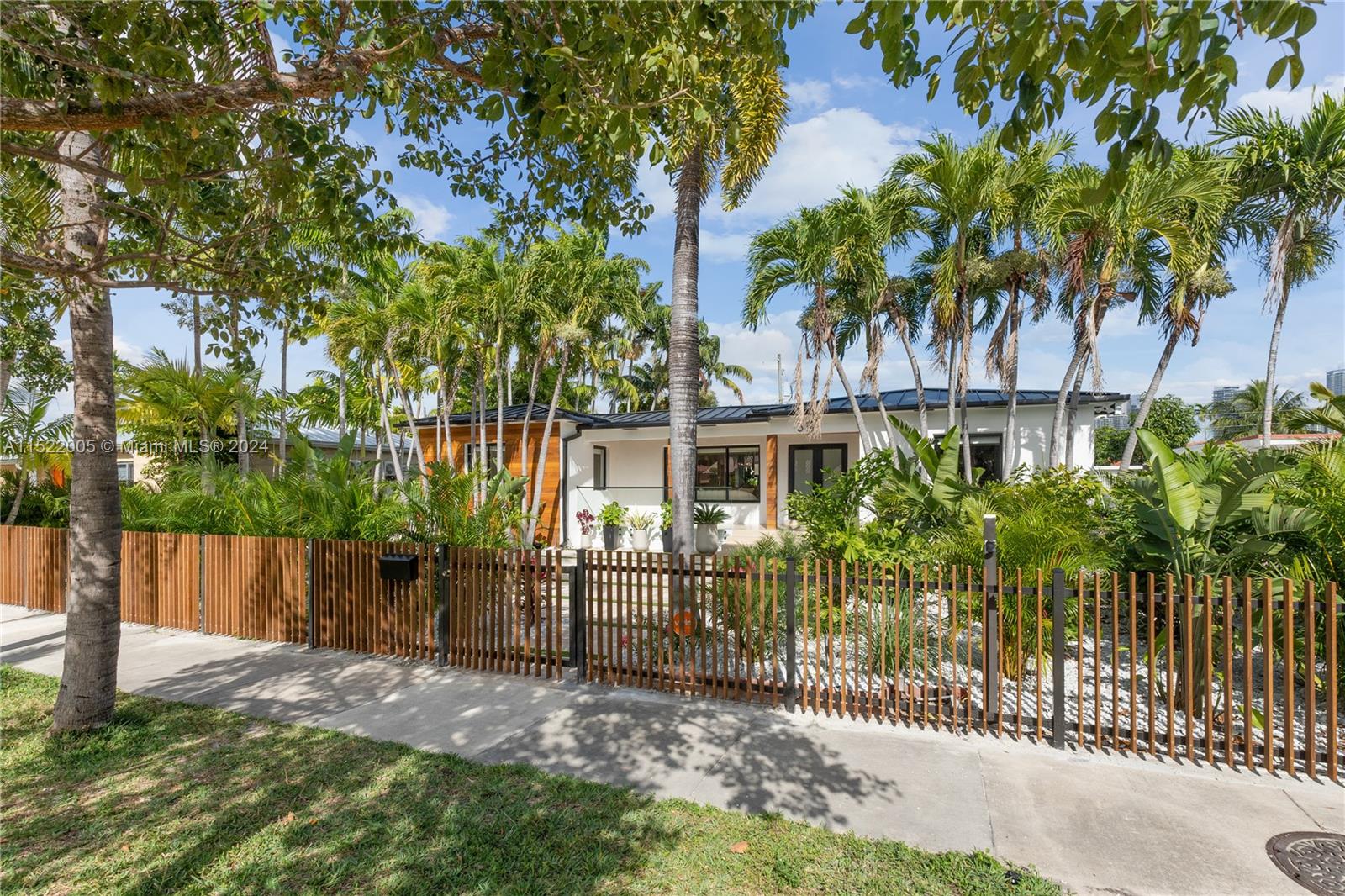 519 Southwest 25th Road Miami, FL 33129 - Photo 37 of 43 a view of a entrance gate of a house and tree