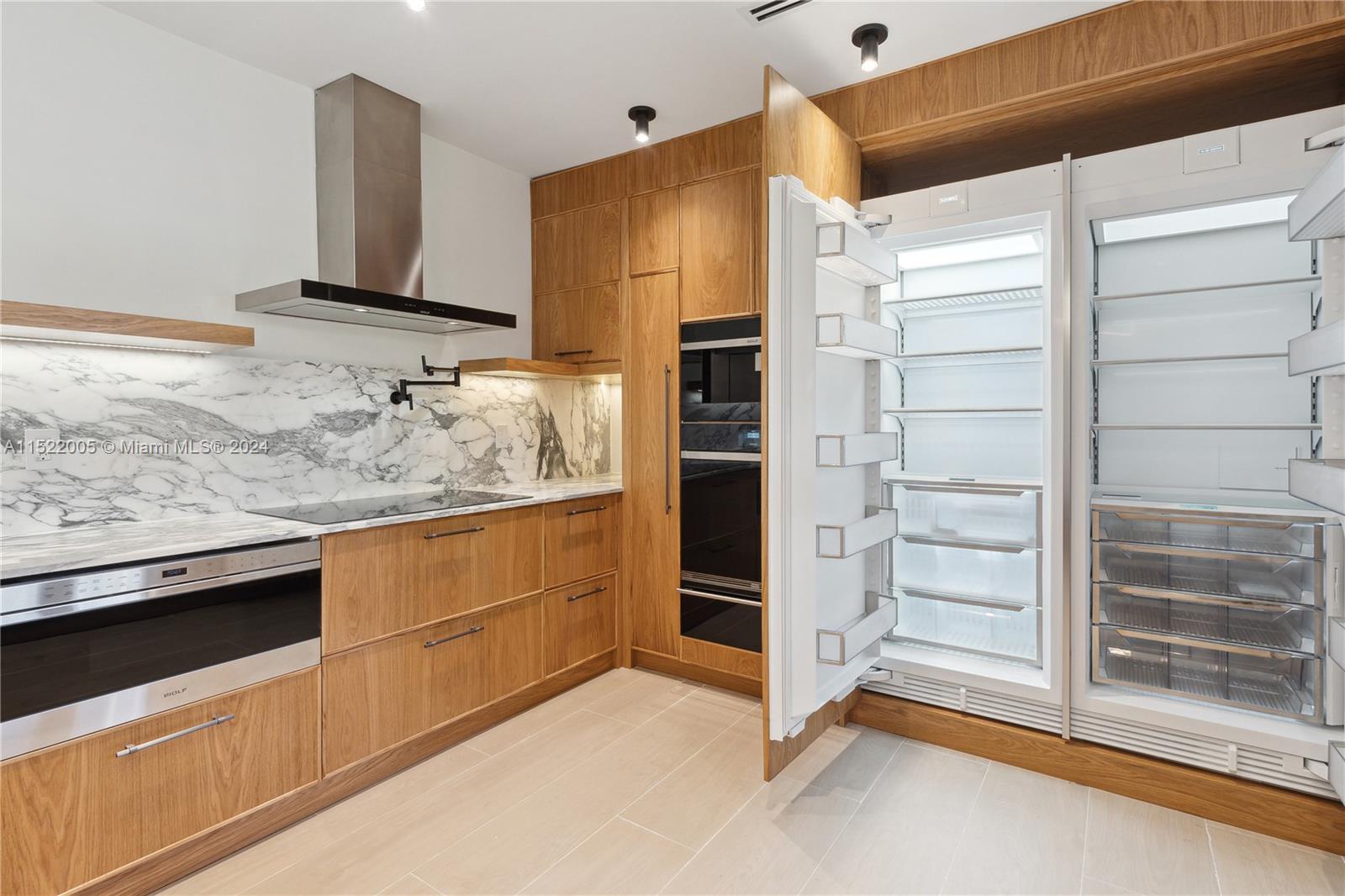 519 Southwest 25th Road Miami, FL 33129 - Photo 7 of 43 a kitchen with stainless steel appliances granite countertop a sink and a refrigerator