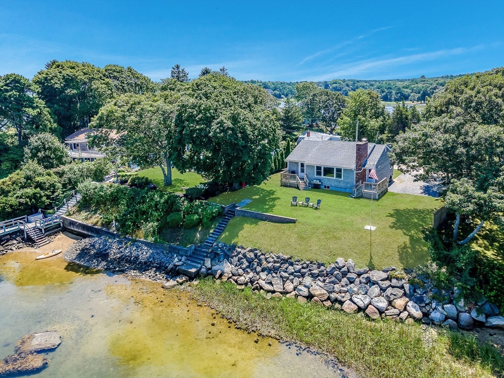27 Over Jordan Road Wareham, MA 02571 - Photo 2 of 28 a view of a lake with a house in the background