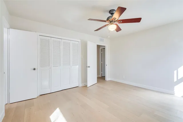 a view of a yard in front of a house with large trees