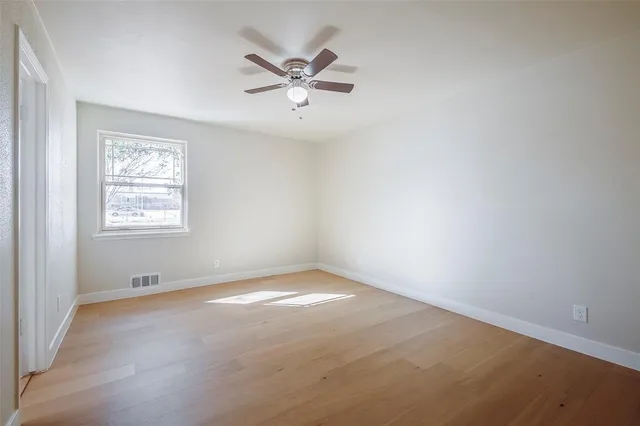a view of a yard with wooden fence