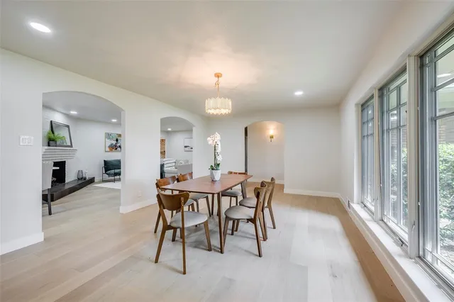 a view of a dining room with furniture and a large window