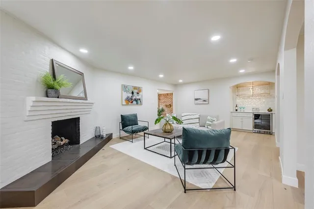 a living room with furniture a fireplace and a table