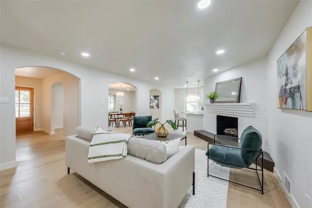 a living room with furniture a fireplace and a potted plant