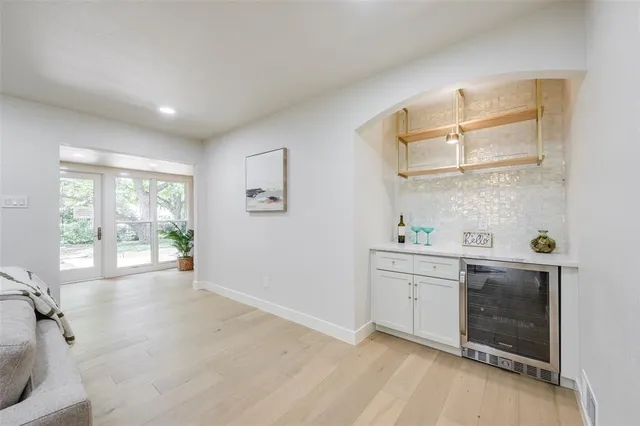 a view of a kitchen with a sink dishwasher and wooden floor