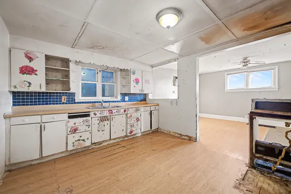 a kitchen with stainless steel appliances granite countertop a sink and cabinets