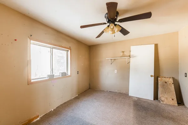 a view of a livingroom with a ceiling fan and window