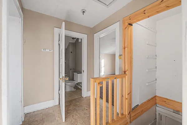 a view of a hallway with a livingroom and a bathroom