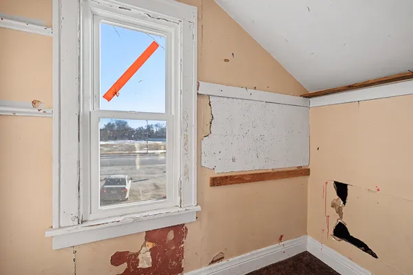 a room that has a window and a shower curtain