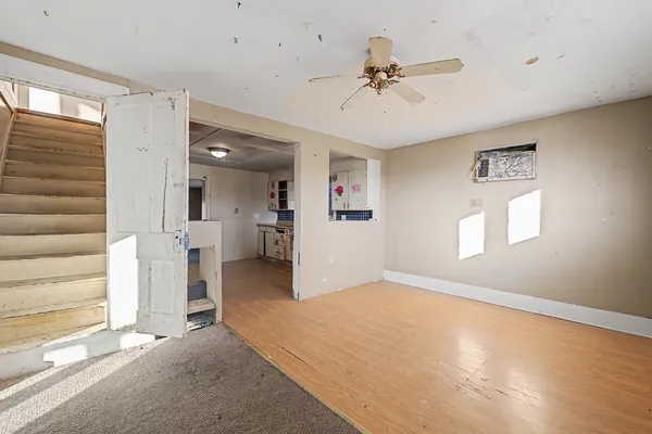 a view of a livingroom with a ceiling fan and window