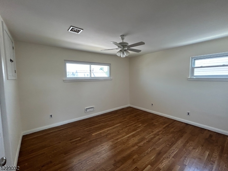 2724 Hickory Road Union, NJ 07083 - Photo 11 of 16 an empty room with wooden floor and windows