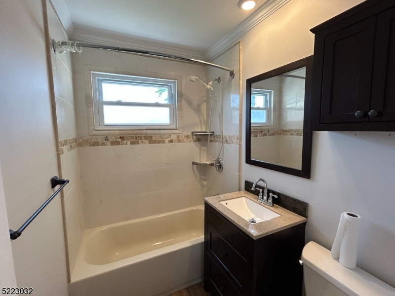 2724 Hickory Road Union, NJ 07083 - Photo 14 of 16 a bathroom with a sink toilet tub and mirror