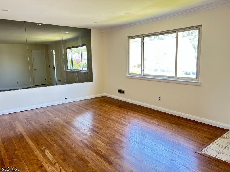 2724 Hickory Road Union, NJ 07083 - Photo 3 of 16 a view of an empty room with wooden floor and a window