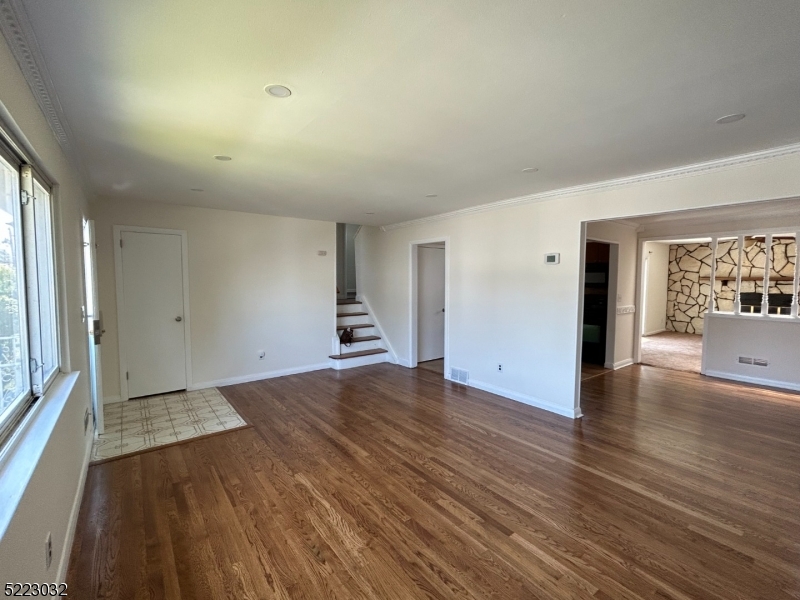 2724 Hickory Road Union, NJ 07083 - Photo 4 of 16 a view of empty room with wooden floor and fireplace