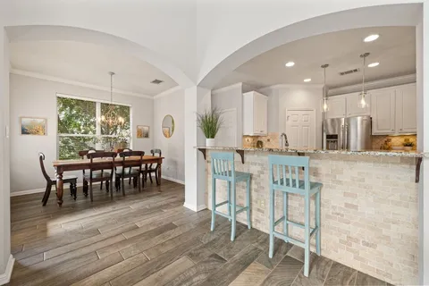 a view of a dining room with furniture and wooden floor