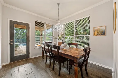 a view of a dining room with furniture window and wooden floor