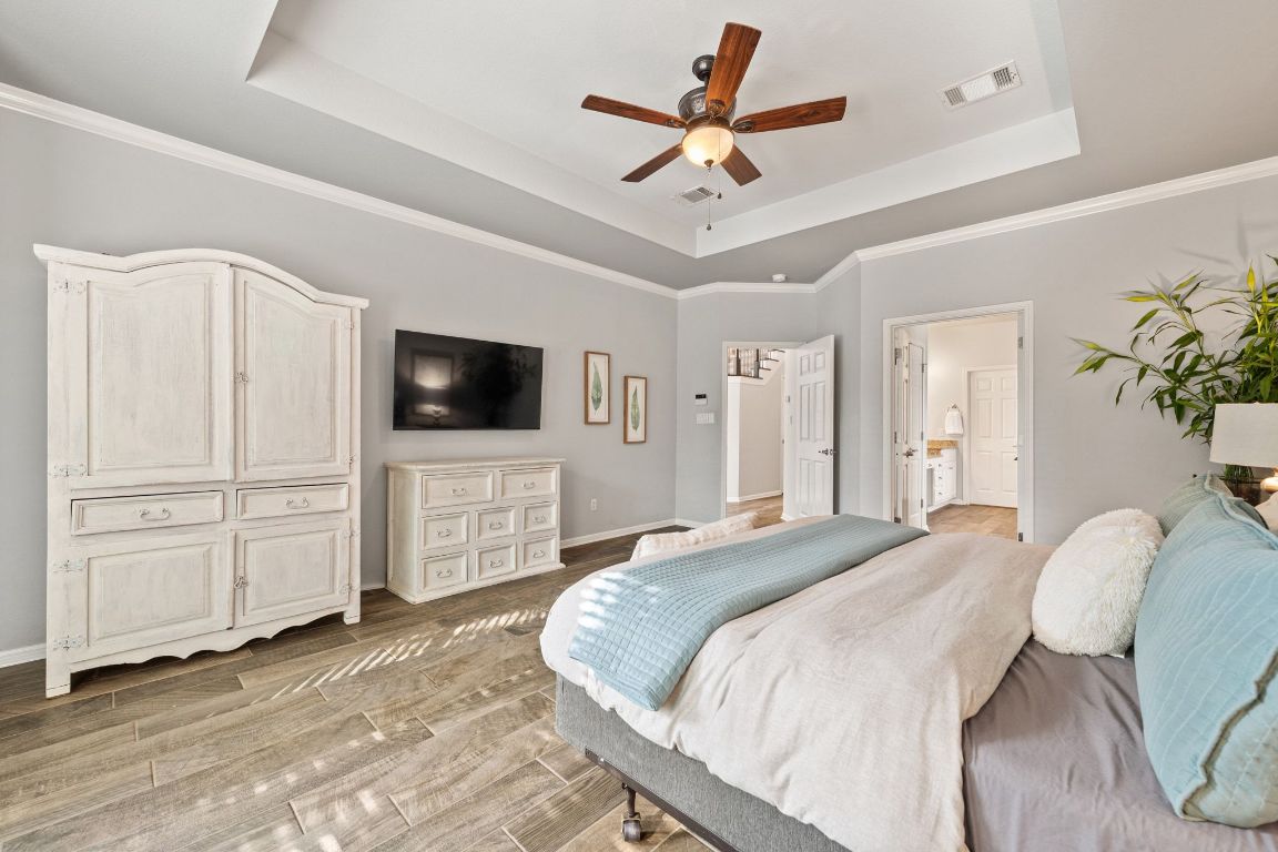3209 Indigo Waters Drive Austin, TX 78732 - Photo 18 of 40 a spacious bedroom with a bed and a flat screen tv
