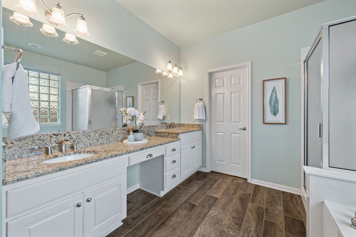 3209 Indigo Waters Drive Austin, TX 78732 - Photo 20 of 40 a bathroom with a double vanity sink and a mirror