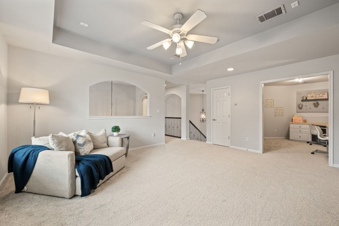 3209 Indigo Waters Drive Austin, TX 78732 - Photo 22 of 40 a living room with furniture and a chandelier