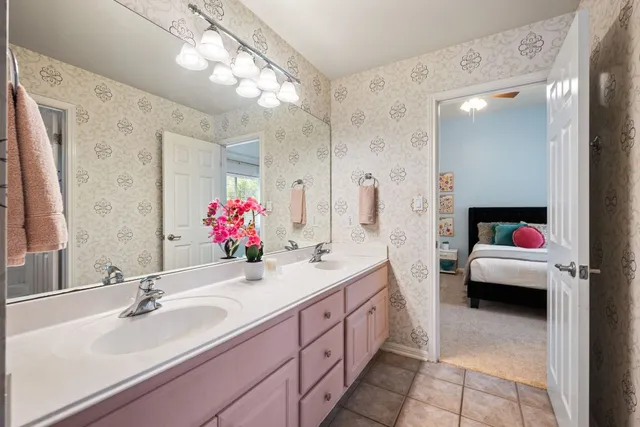 a bathroom with a tub sink and mirror