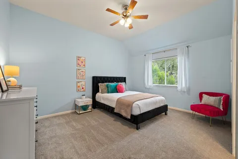 a bedroom with a bed and a window