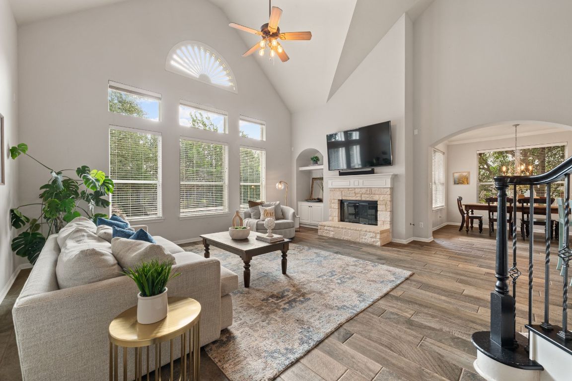 3209 Indigo Waters Drive Austin, TX 78732 - Photo 3 of 40 a living room with furniture fireplace and flat screen tv