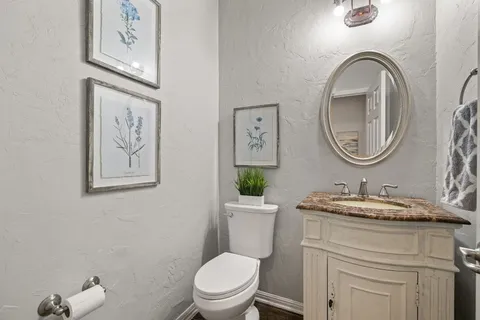 a bathroom with a toilet a sink and mirror