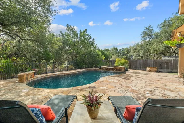 a view of a backyard with swimming pool