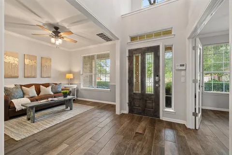 a living room with furniture and wooden floor