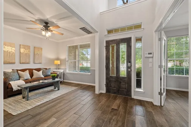 a living room with furniture and wooden floor