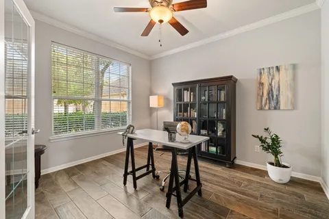 a workspace with furniture window and wooden floor