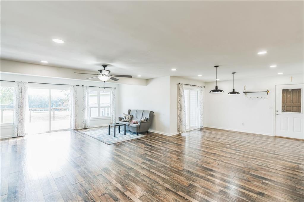 500 Coleman Mill Road Carrollton, GA 30116 - Photo 13 of 83 a view of a livingroom with furniture a ceiling fan and wooden floor