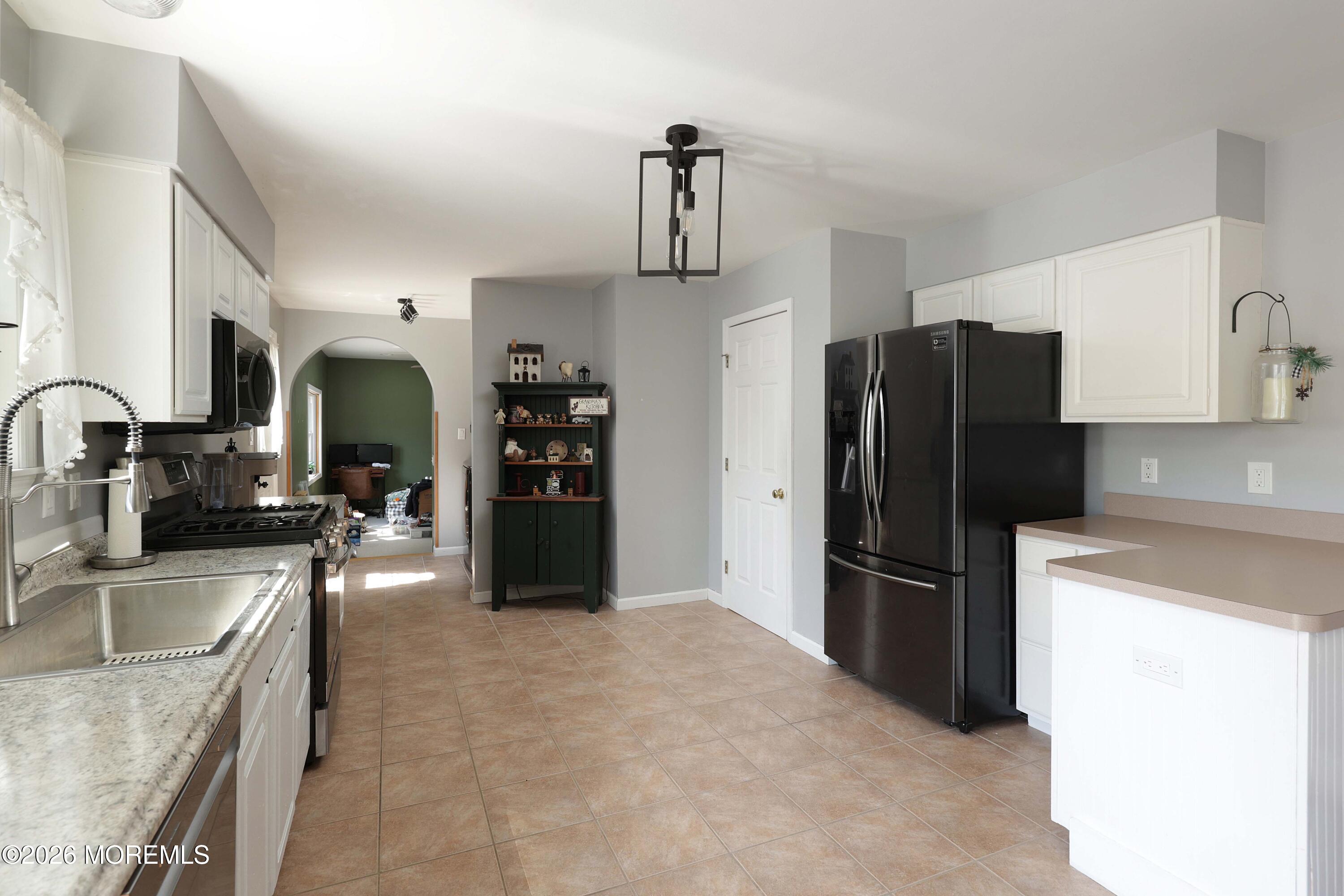 96 Atrium Drive Brick, NJ 08723 - Photo 11 of 39 a kitchen with stainless steel appliances granite countertop a refrigerator and a sink