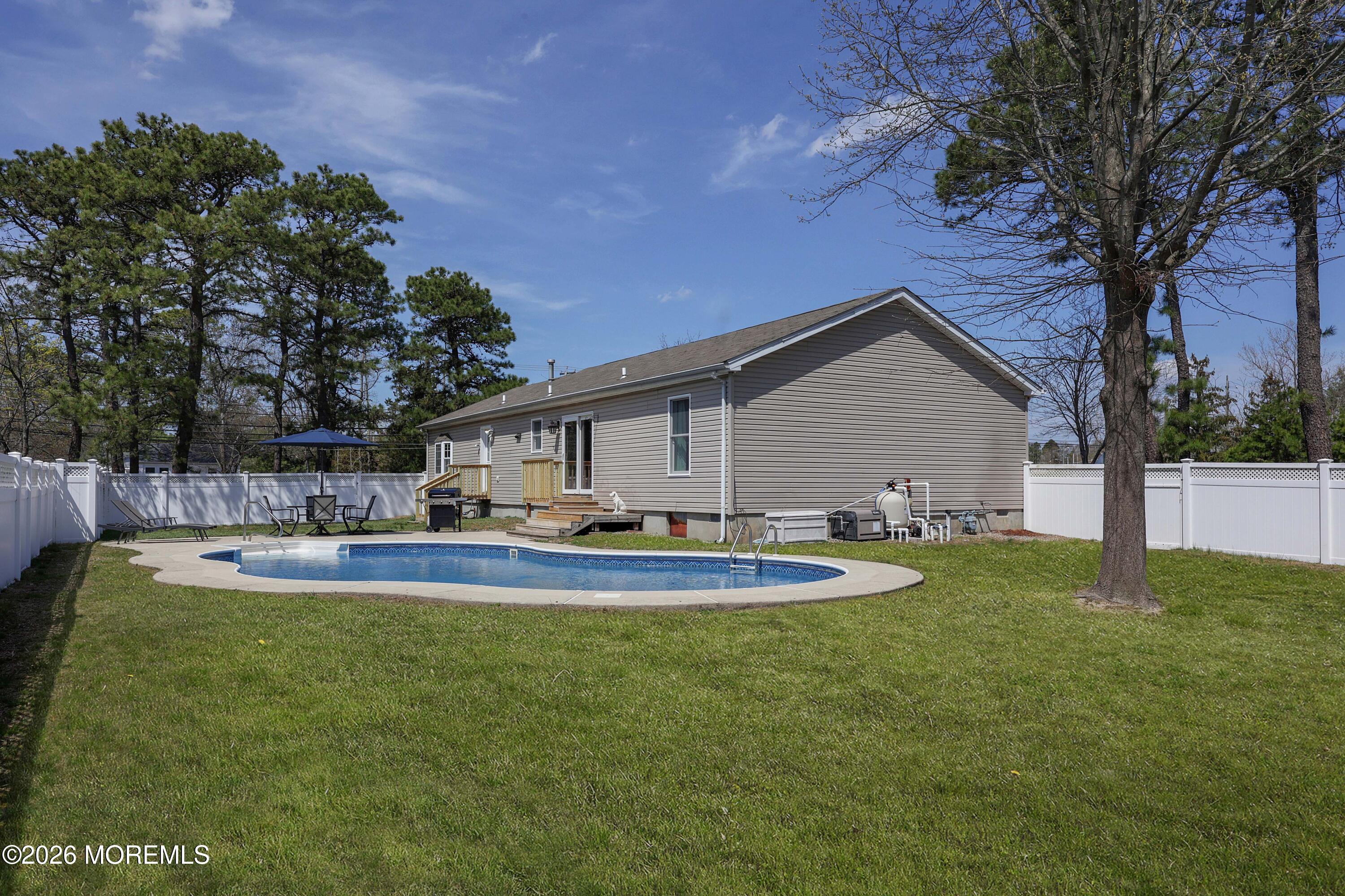 96 Atrium Drive Brick, NJ 08723 - Photo 24 of 39 a front view of house with yard and trees
