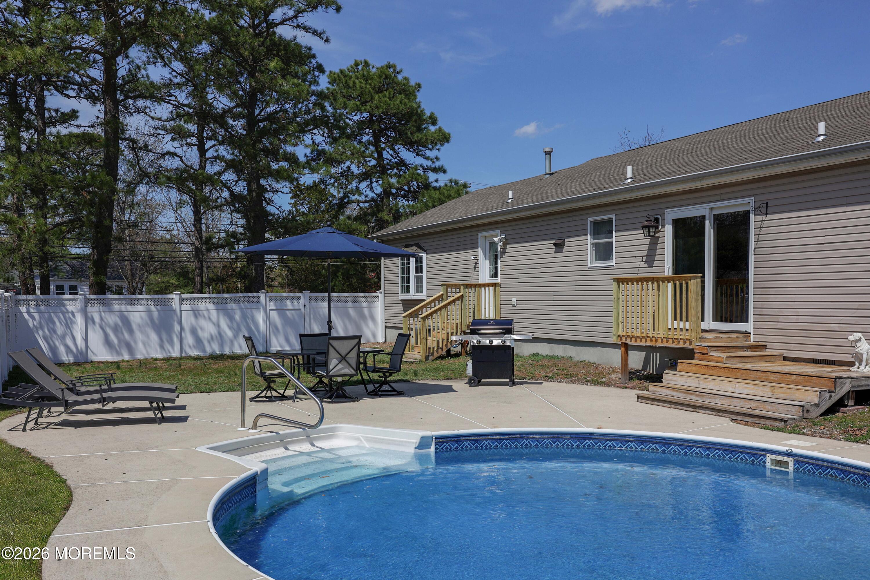96 Atrium Drive Brick, NJ 08723 - Photo 25 of 39 a view of a chairs and tables in the back yard of the house