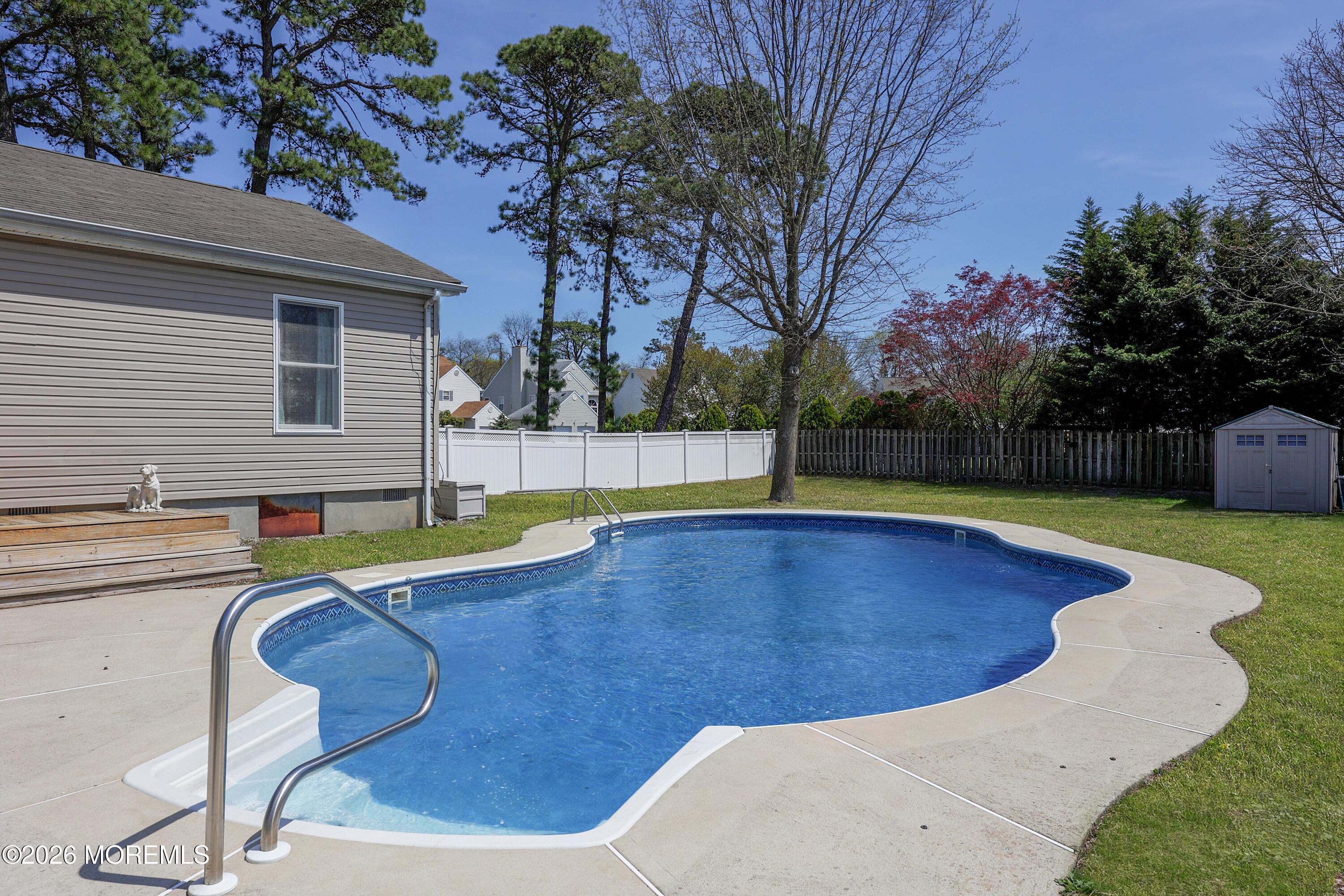 96 Atrium Drive Brick, NJ 08723 - Photo 28 of 39 a view of a swimming pool with a yard