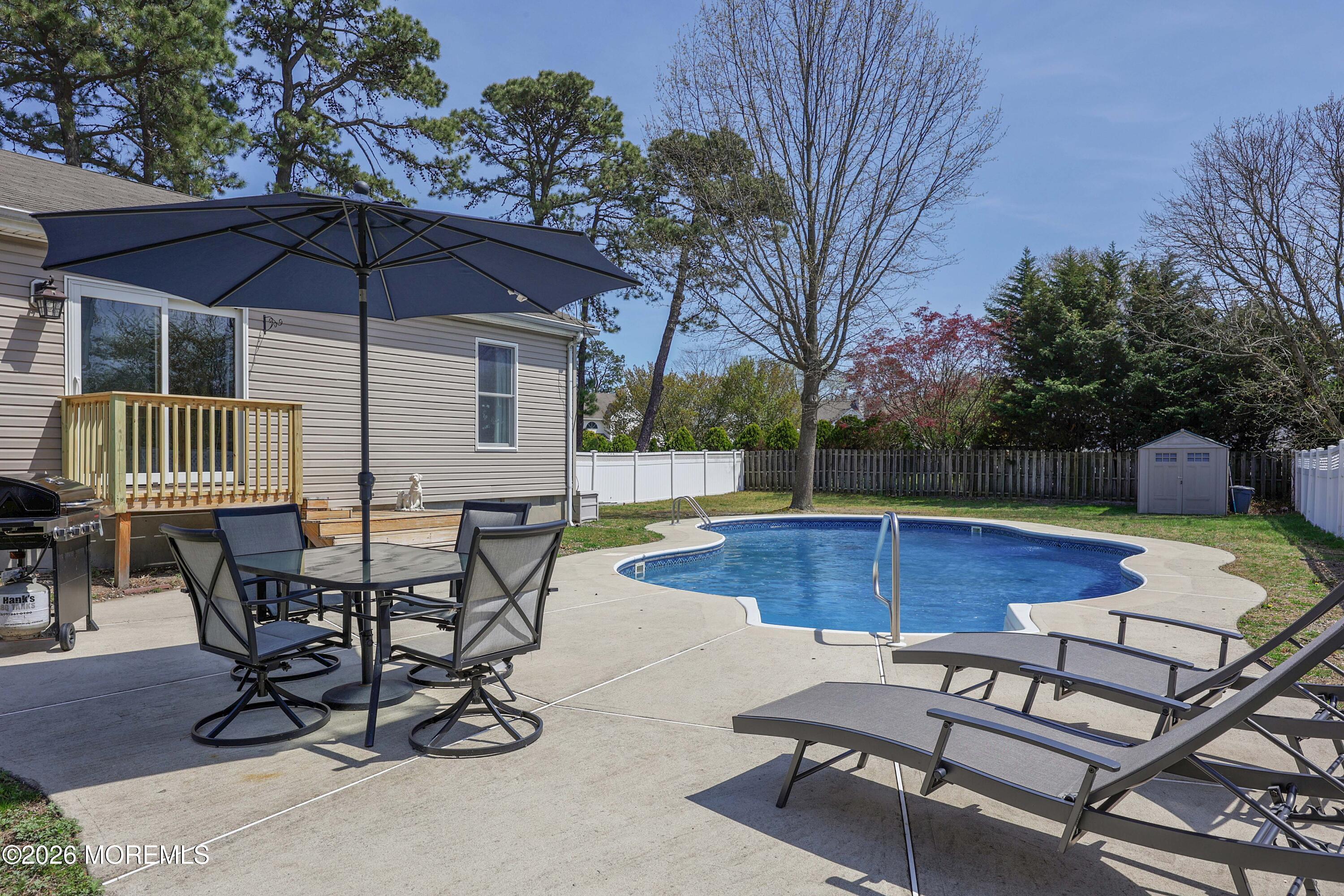 96 Atrium Drive Brick, NJ 08723 - Photo 36 of 39 a patio with a table and chairs