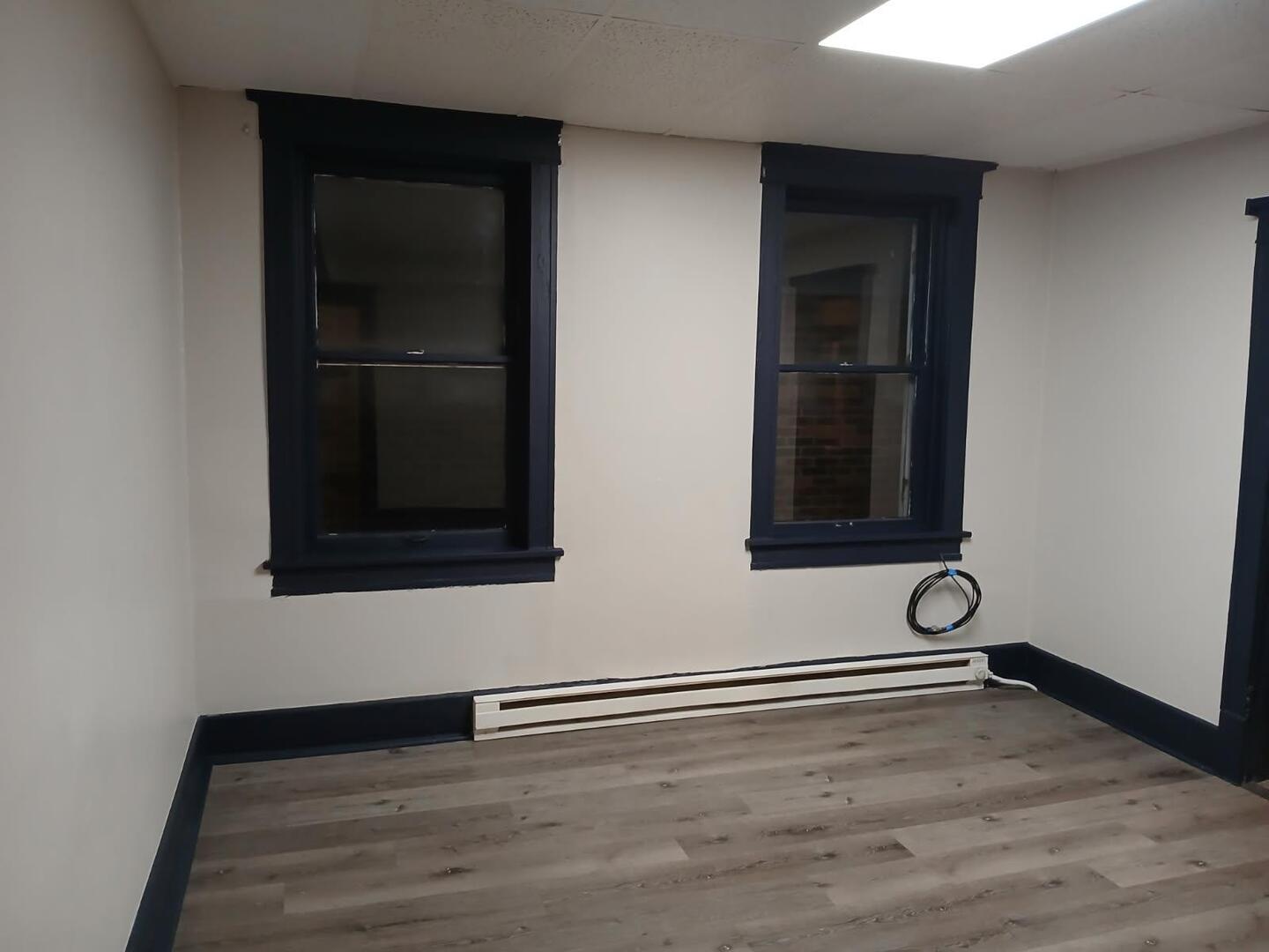 1818 4th Street, Unit 2 Peru, IL 61354 - Photo 9 of 13 a view of an empty room with wooden floor and a window